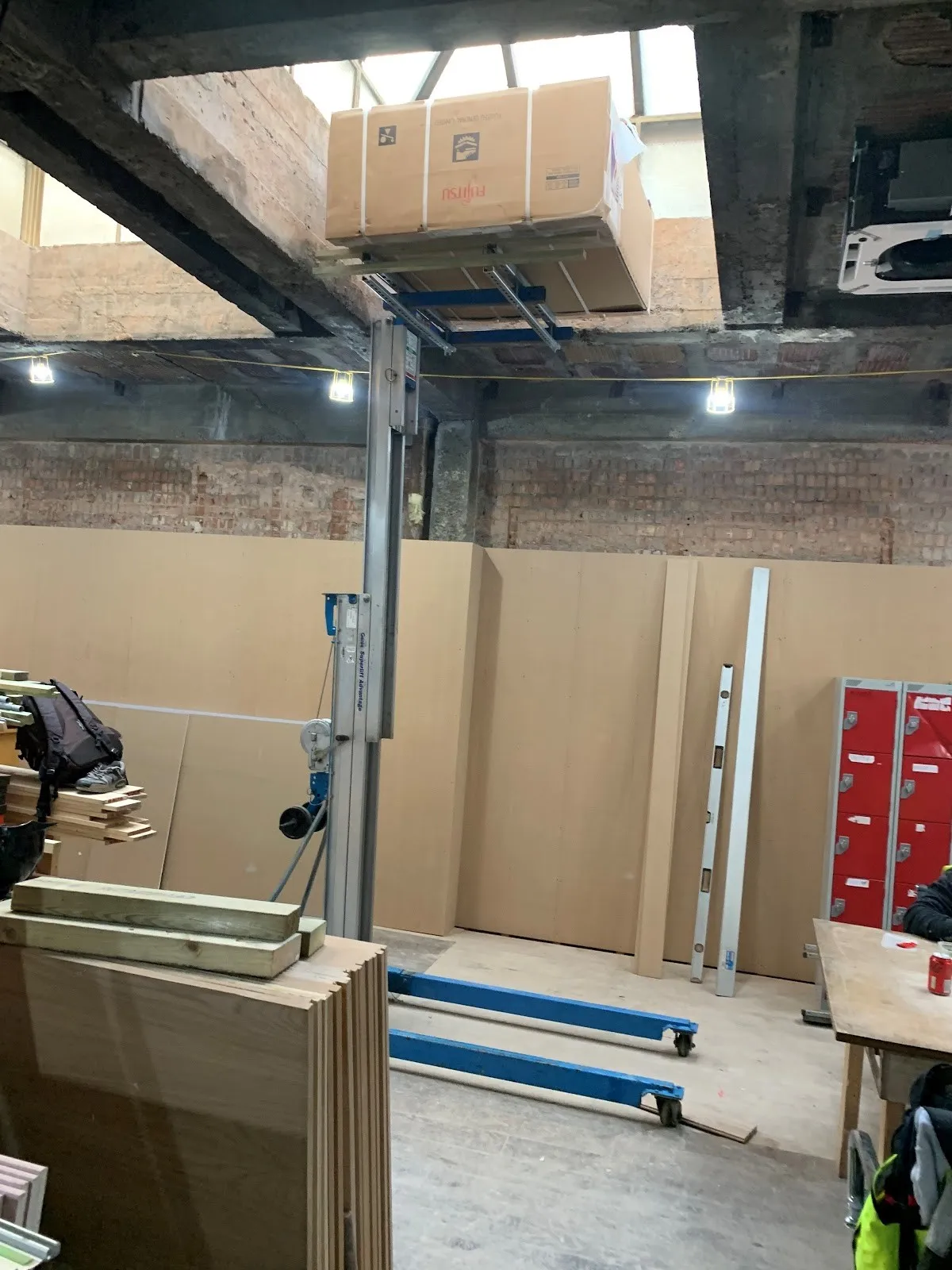 Ducted unit going into a ceiling void. Lifted into place on a commercial fit-out.