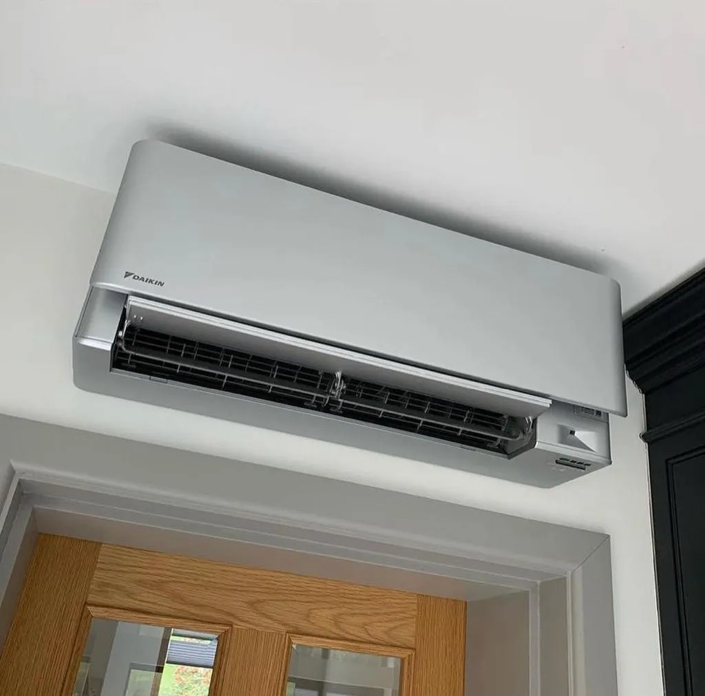 Daikin wall unit in silver. Fitted neatly above a doorway.